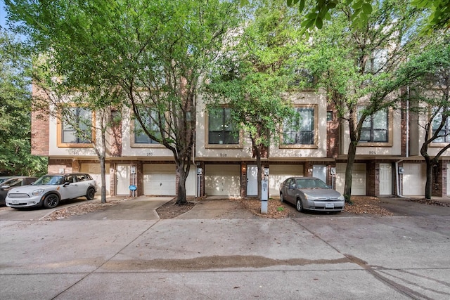 908 Glenn Crossett St, Arlington, TX 76010 - view of property featuring an attached garage, driveway, and brick siding