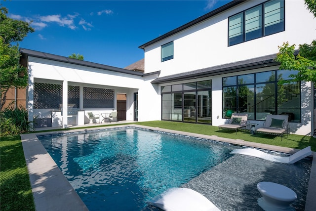 back of property featuring stucco siding, area for grilling, and a patio area