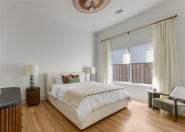 bedroom featuring wood finished floors and baseboards