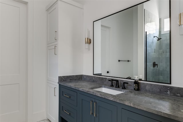bathroom with a shower stall and vanity