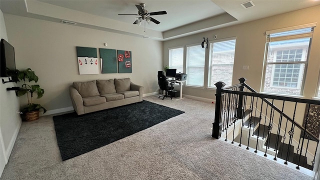 4557 El Paso Dr, Plano, TX 75024 - carpeted living area featuring a raised ceiling, ceiling fan, baseboards, and a desk
