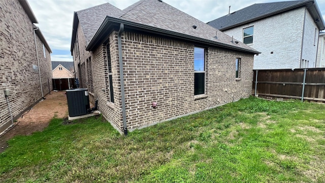4557 El Paso Dr, Plano, TX 75024 - back of house with central air condition unit, brick siding, and a shingled roof