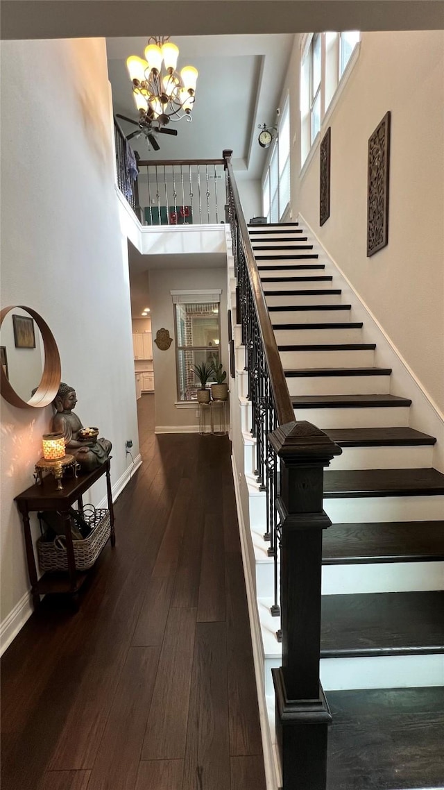 4557 El Paso Dr, Plano, TX 75024 - staircase with a chandelier, wood finished floors, baseboards, and a towering ceiling
