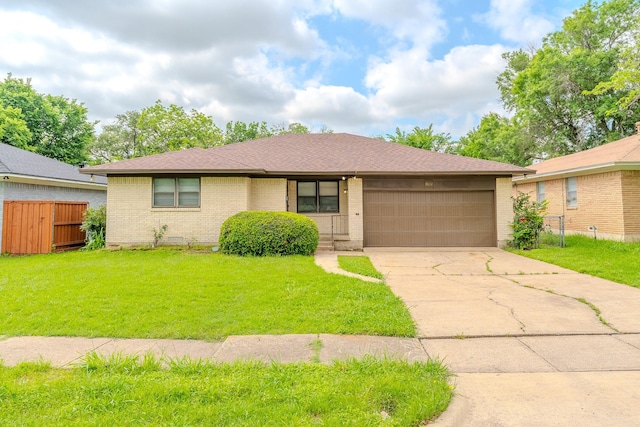 8652 Wolfwood Ln, Dallas, TX 75217 - view of front of house with a garage, driveway, brick siding, and roof with shingles