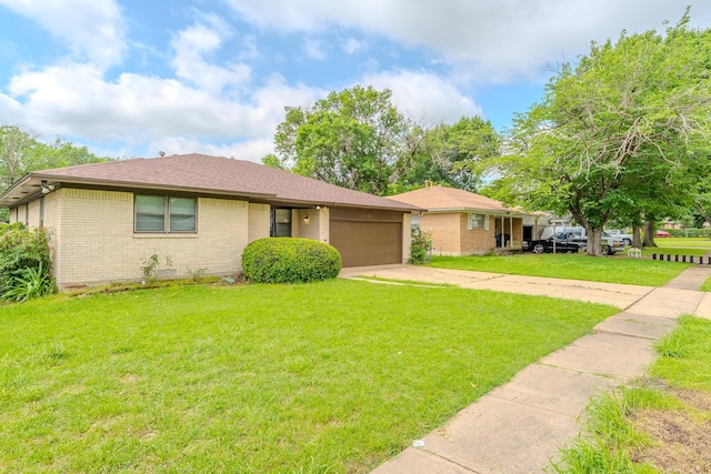 8652 Wolfwood Ln, Dallas, TX 75217 - view of front of home with an attached garage, driveway, brick siding, and a front yard