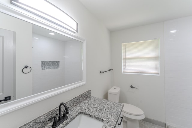 8652 Wolfwood Ln, Dallas, TX 75217 - bathroom with toilet, vanity, and tile patterned floors