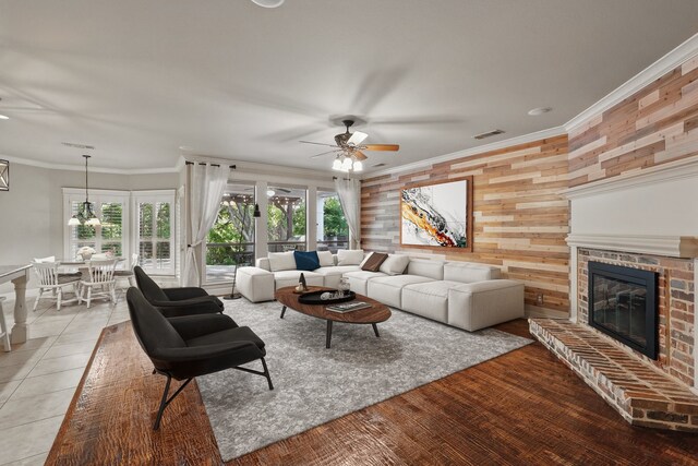 1309 Constitution Dr, Mckinney, TX 75071 - living room with ceiling fan, a fireplace, plenty of natural light, crown molding, and wooden walls