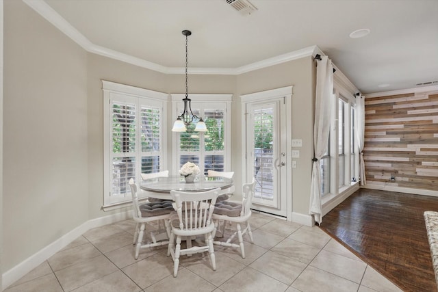 1309 Constitution Dr, Mckinney, TX 75071 - dining space featuring light tile patterned floors, baseboards, healthy amount of natural light, and crown molding