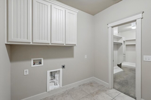 1309 Constitution Dr, Mckinney, TX 75071 - laundry area featuring hookup for an electric dryer, hookup for a washing machine, cabinet space, baseboards, and light tile patterned floors