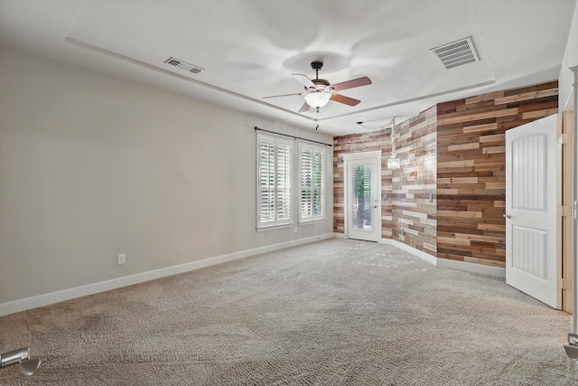 1309 Constitution Dr, Mckinney, TX 75071 - unfurnished room with a ceiling fan, baseboards, wooden walls, and carpet flooring