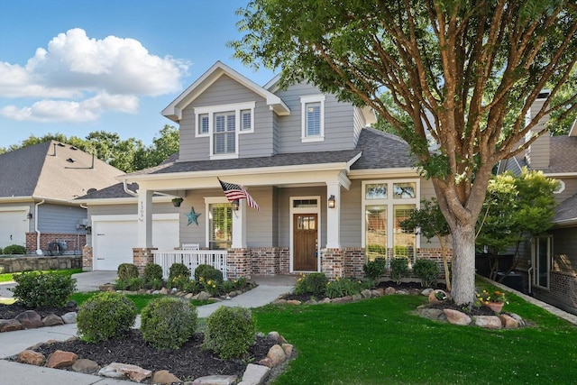 1309 Constitution Dr, Mckinney, TX 75071 - view of front of property featuring a porch, a front lawn, brick siding, and a shingled roof