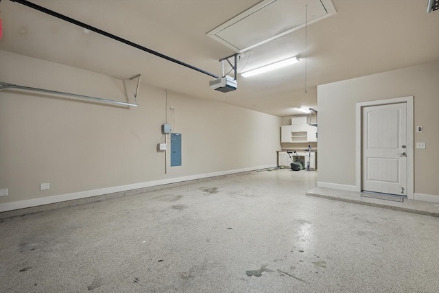 1309 Constitution Dr, Mckinney, TX 75071 - garage featuring a garage door opener, electric panel, and baseboards