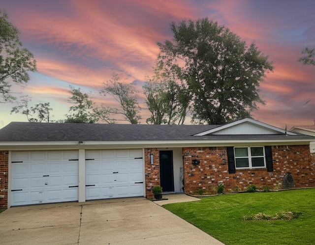 1709 Pamela Ln, Fort Worth, TX 76112 - ranch-style house featuring brick siding, an attached garage, driveway, and a lawn
