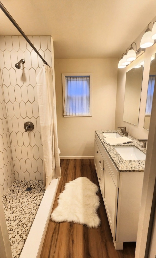 1709 Pamela Ln, Fort Worth, TX 76112 - full bath featuring wood finished floors, a stall shower, double vanity, and baseboards