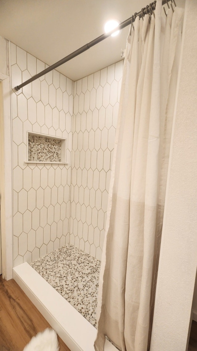 1709 Pamela Ln, Fort Worth, TX 76112 - bathroom featuring wood finished floors and tiled shower