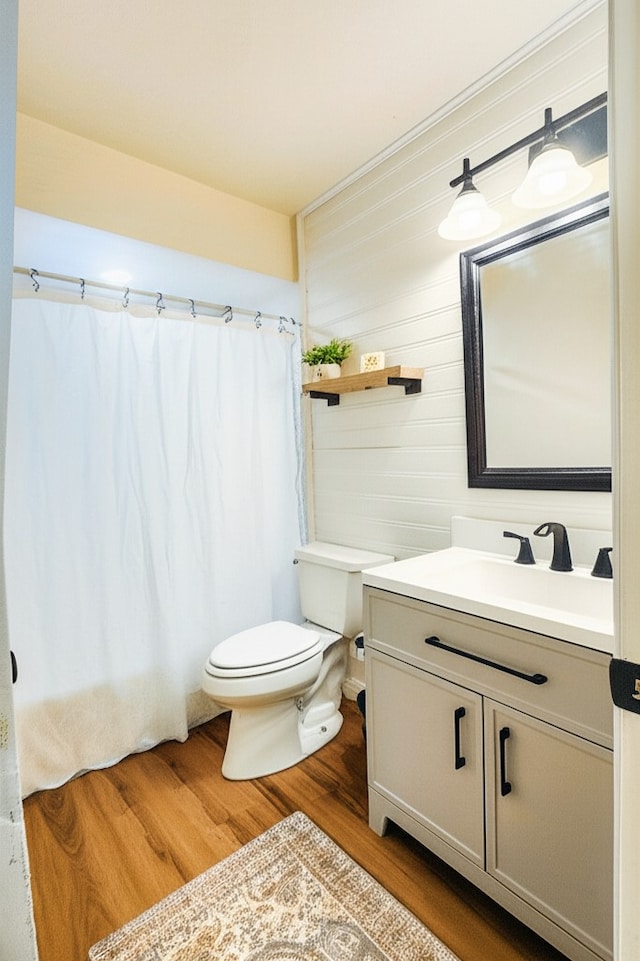 1709 Pamela Ln, Fort Worth, TX 76112 - bathroom with toilet, wood finished floors, vanity, and curtained shower