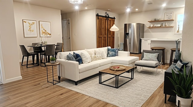 1709 Pamela Ln, Fort Worth, TX 76112 - living area with a barn door, light wood-style floors, recessed lighting, and baseboards