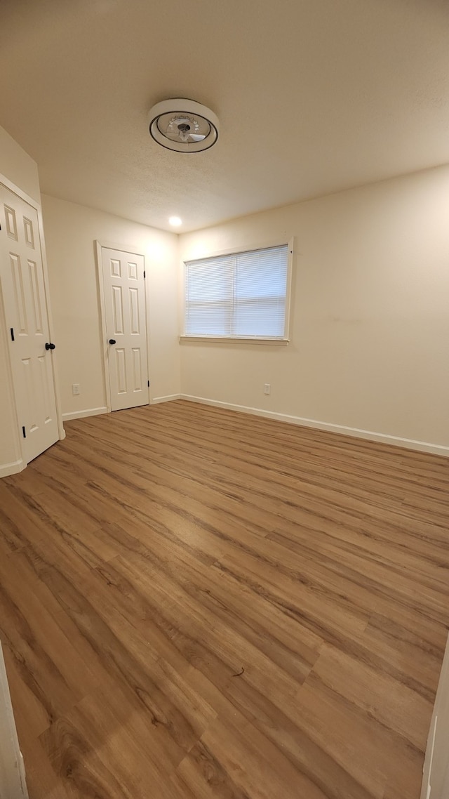 1709 Pamela Ln, Fort Worth, TX 76112 - unfurnished bedroom featuring wood finished floors and baseboards
