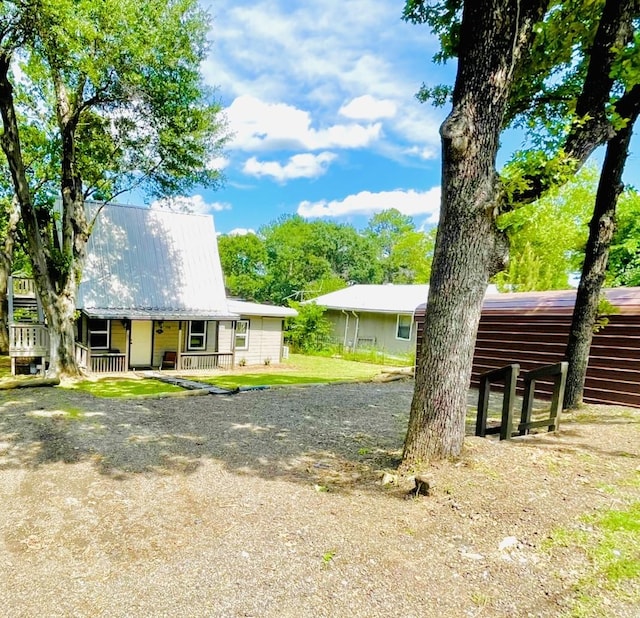 118 Ricky Rd, Gun Barrel City, TX 75156 - back of property featuring covered porch, metal roof, and driveway