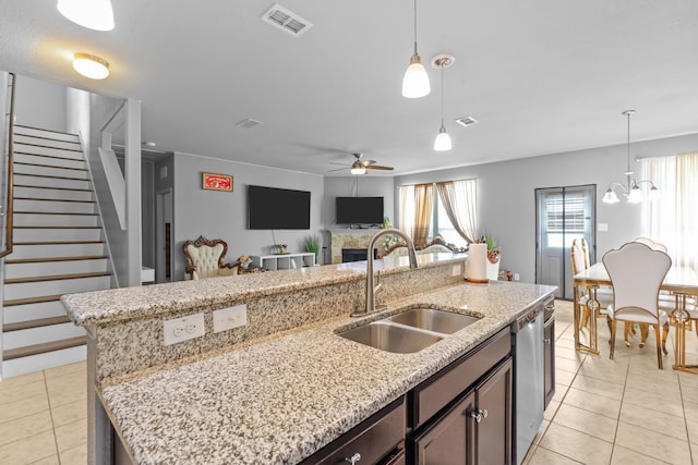 2304 Bermont Red Ln, Fort Worth, TX 76131 - kitchen with a sink, light tile patterned flooring, an island with sink, and stainless steel dishwasher