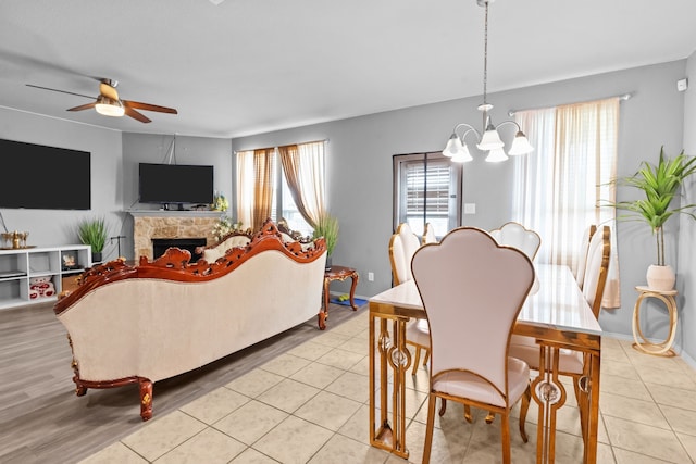 2304 Bermont Red Ln, Fort Worth, TX 76131 - living room featuring ceiling fan, a chandelier, a fireplace, and light tile patterned floors
