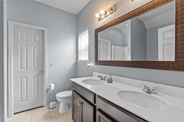 2304 Bermont Red Ln, Fort Worth, TX 76131 - full bath featuring toilet, double vanity, a textured wall, tile patterned flooring, and baseboards