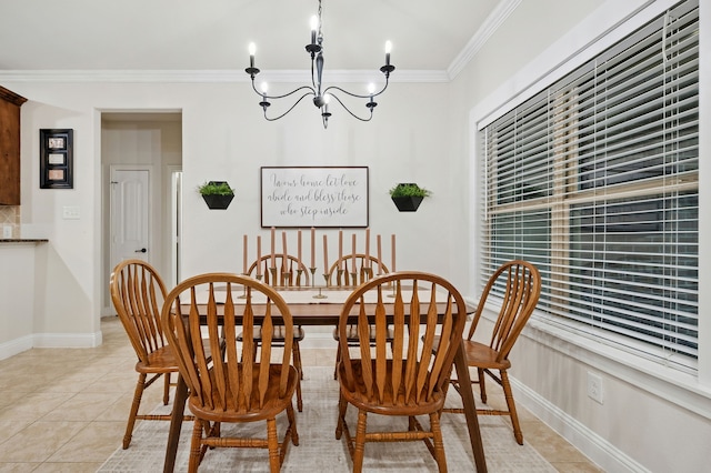 dining area featuring a chandelier, crown molding, light tile patterned flooring, and baseboards