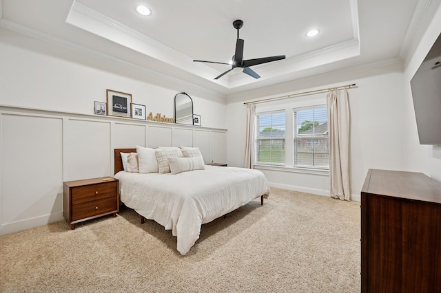 carpeted bedroom featuring a raised ceiling, crown molding, recessed lighting, and ceiling fan