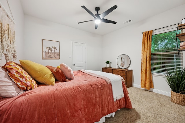 carpeted bedroom with baseboards and ceiling fan