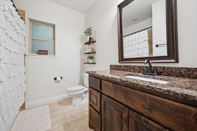 full bath with baseboards, toilet, vanity, and tile patterned floors