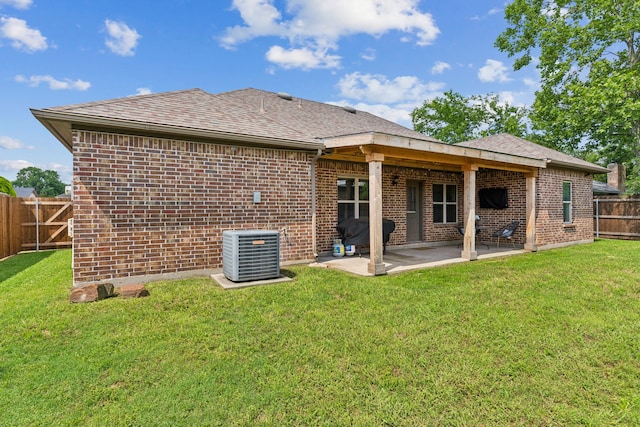 back of house with central AC, brick siding, a patio area, and a shingled roof