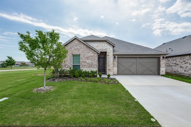 7332 Carnation St, Little Elm, TX 76227 - french country inspired facade featuring a garage, brick siding, a front lawn, concrete driveway, and roof with shingles