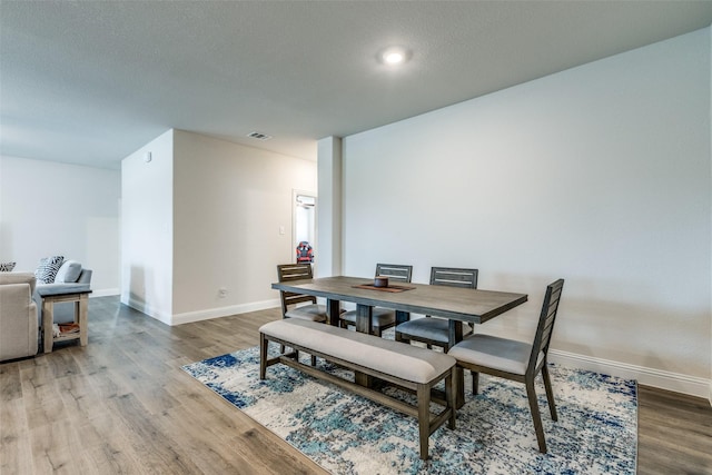 7332 Carnation St, Little Elm, TX 76227 - dining room with baseboards, wood finished floors, and a textured ceiling