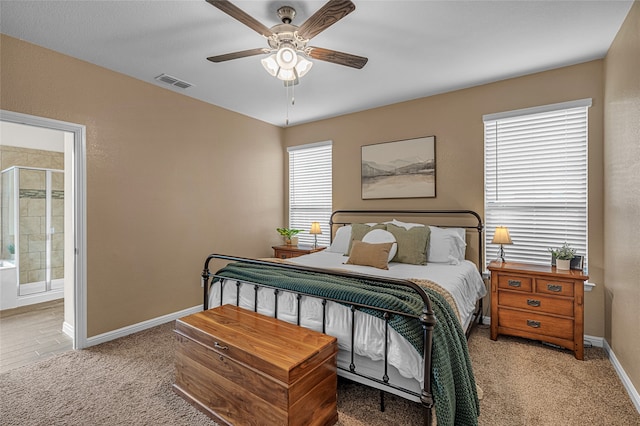 411 Skipper Ln, Azle, TX 76020 - bedroom featuring light carpet, baseboards, ensuite bathroom, and a ceiling fan
