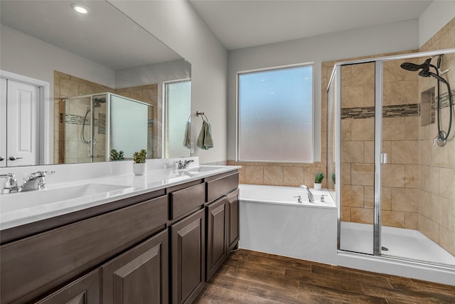 411 Skipper Ln, Azle, TX 76020 - bathroom featuring a stall shower, a bath, double vanity, and wood finished floors