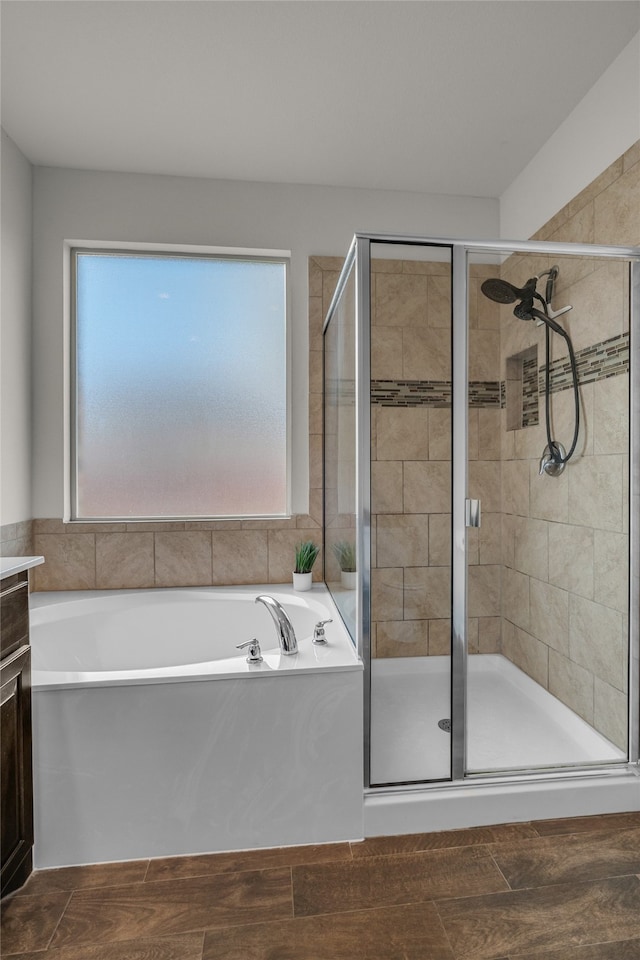 411 Skipper Ln, Azle, TX 76020 - bathroom featuring a shower stall, a bath, vanity, and wood finished floors