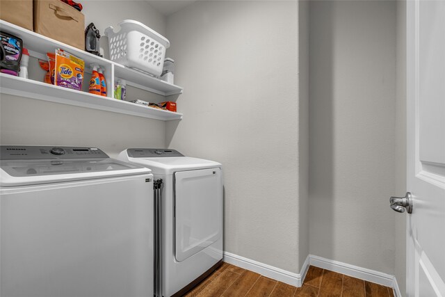 411 Skipper Ln, Azle, TX 76020 - laundry room featuring washer and clothes dryer, baseboards, and wood finished floors