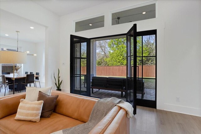 living area featuring wood finished floors, baseboards, and recessed lighting