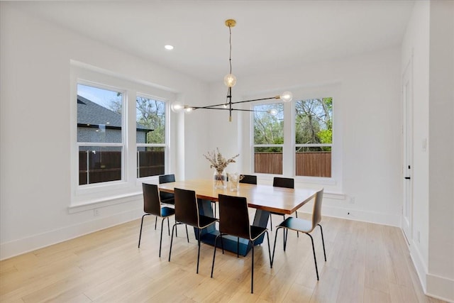 dining room with a chandelier, plenty of natural light, baseboards, light wood-style flooring, and recessed lighting