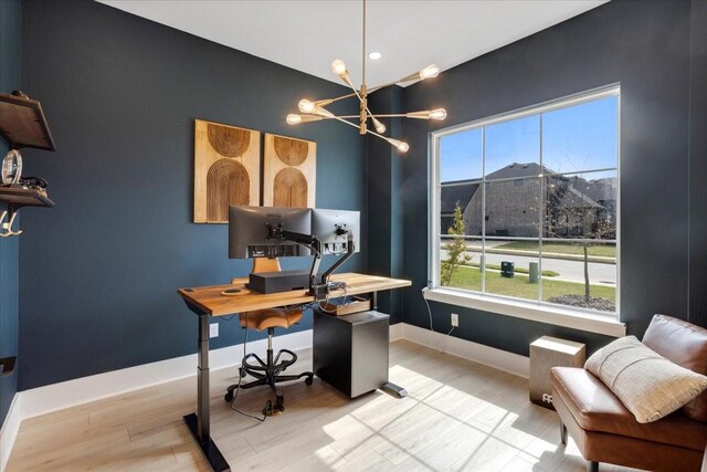 office featuring a chandelier, light wood-style floors, and baseboards