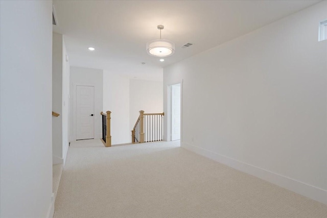 spare room with carpet, recessed lighting, and baseboards