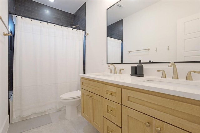 full bathroom featuring toilet, double vanity, tile patterned floors, and shower / tub combo with curtain