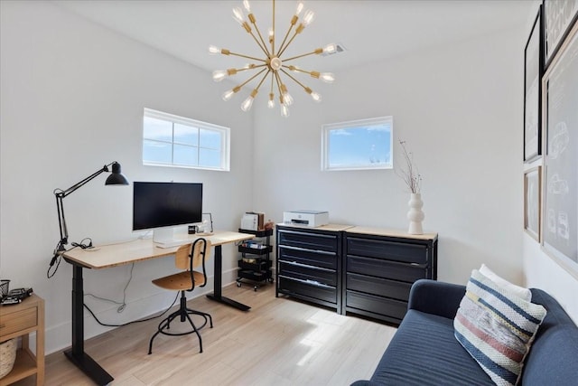 home office with plenty of natural light, a chandelier, and light wood-type flooring