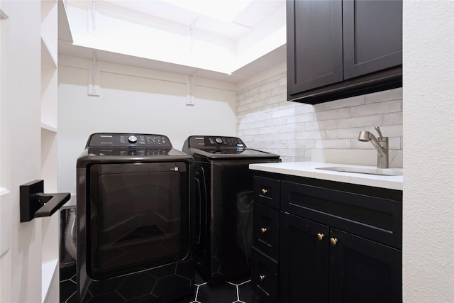 laundry area featuring independent washer and dryer, cabinet space, and tile patterned floors