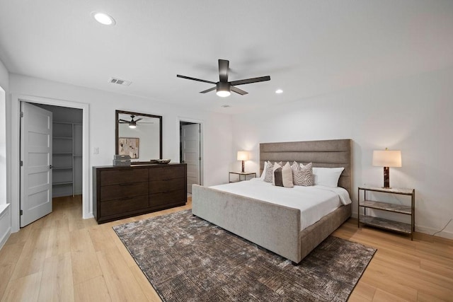 1500 W Virginia St, Mckinney, TX 75069 - bedroom with light wood-style flooring, a walk in closet, recessed lighting, ceiling fan, and baseboards