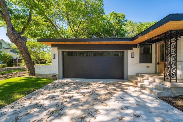 1500 W Virginia St, Mckinney, TX 75069 - view of front of house featuring brick siding, driveway, and a garage