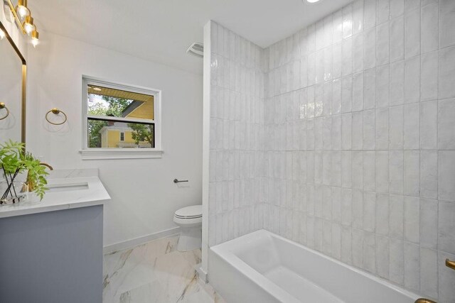 1500 W Virginia St, Mckinney, TX 75069 - bathroom featuring toilet, vanity, baseboards, marble finish flooring, and shower / tub combination