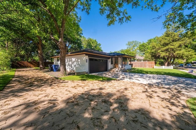 1500 W Virginia St, Mckinney, TX 75069 - view of front of home featuring driveway, an attached garage, and fence