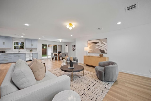 1500 W Virginia St, Mckinney, TX 75069 - living room with light wood-style floors, recessed lighting, and baseboards