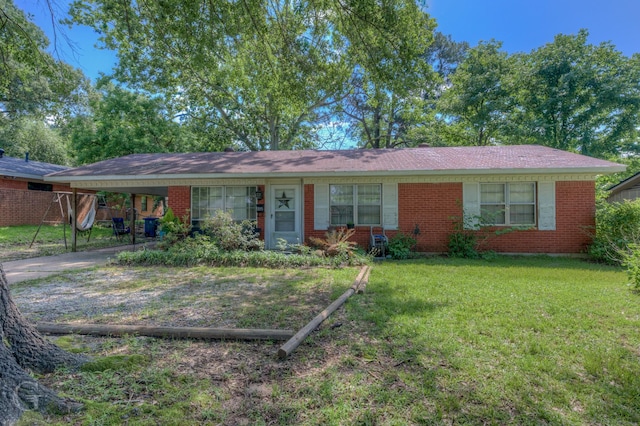 ranch-style home featuring driveway, brick siding, and an attached carport